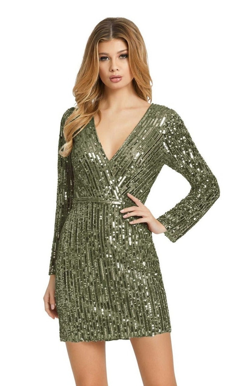 Woman wearing a long sleeve silver sequin cocktail dress (style 41029) stands with one hand on her hip against a white background.